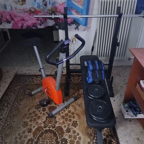 Weight bench with barbell and weights, exercise bike, like new
