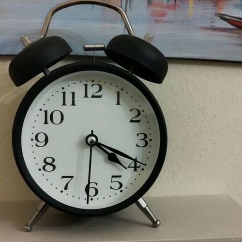 Analog tabletop clock used alarm
