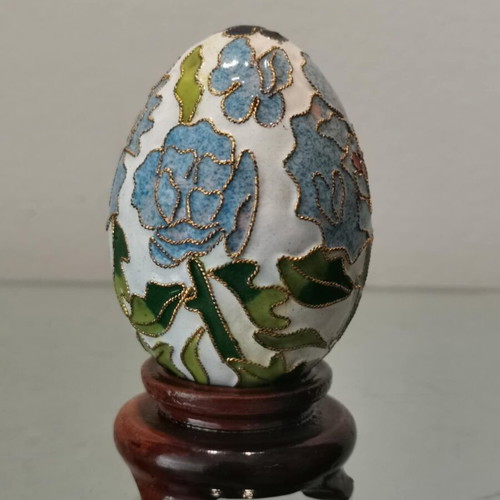 Cloisonne egg used with blue flowers and wooden base