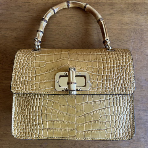 Yellow leather bag with bamboo strap