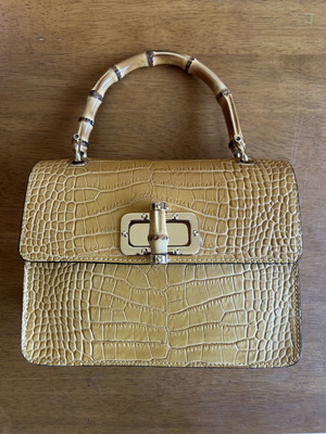 Yellow leather bag with bamboo strap