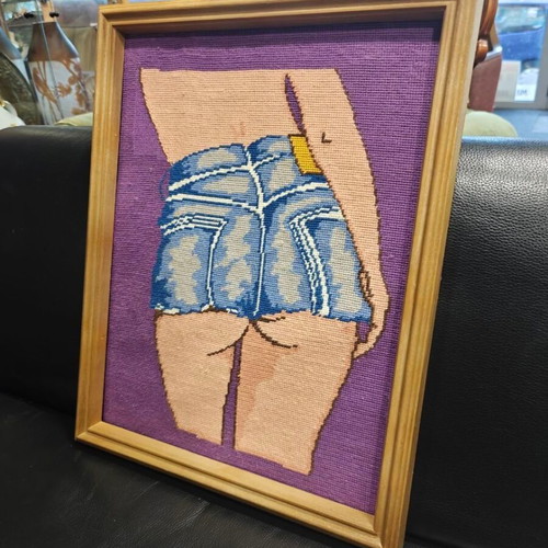 Framed gobelin woman in short denim shorts on purple background used