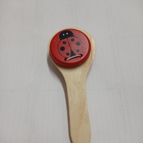 Wooden clapper used with red ladybug