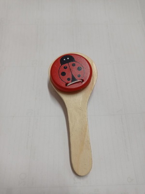Wooden clapper used with red ladybug