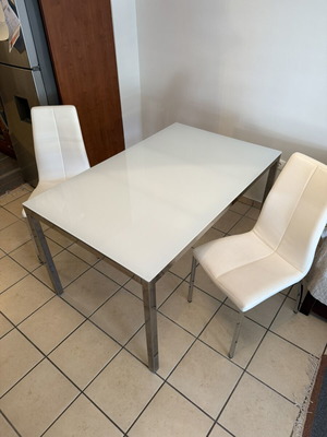 Glass dining table and chair set used, metal frame, white chairs