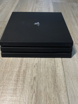 PlayStation 4 Pro 1TB used with 2 controllers and 15 disc games