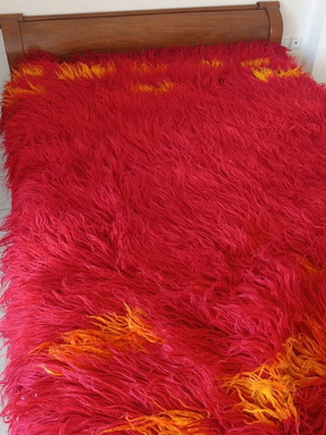 Long pile bed cover blanket, red with orange details