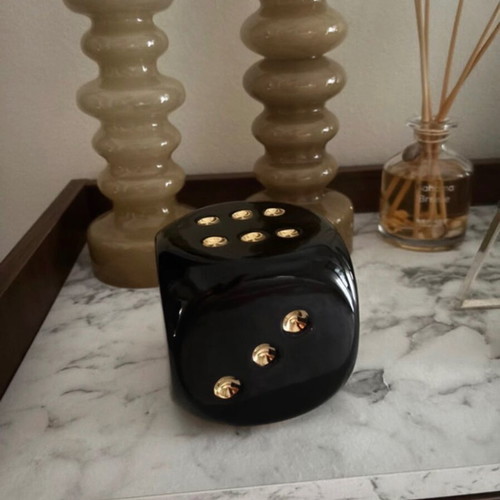 Decorative black dice with gold dots
