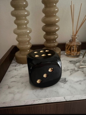 Decorative black dice with gold dots