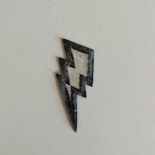 Sewn patch in gold lightning bolt shape like new