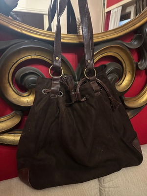 Brown suede shoulder bag used with woven details and drawstring