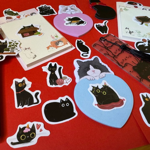Cat-themed stationery set like new with sticky notes, pens, bookmarks, and stickers