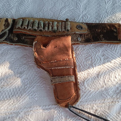 Vintage leather belt with cartridge and pistol holster used