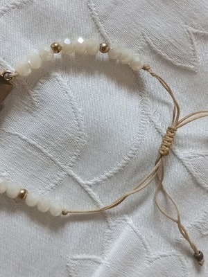Bracelet with white beads and cross, like new, gold and beige details