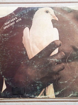 Santana Greatest Hits vinyl record with worn cover, Rock