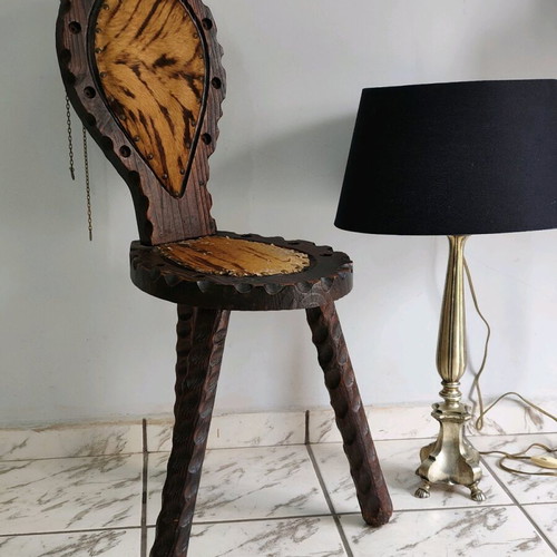 Spanish rustic chair used with three legs and animal leather from the 1960s