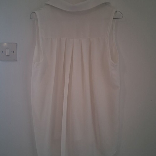 Sleeveless white shirt top