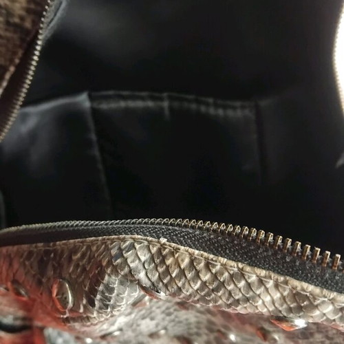 Snakeprint backpack used, grey with snake pattern and studs