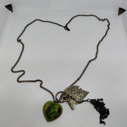 Vintage necklace with antique bronze elements and peacock feather heart pendant like new