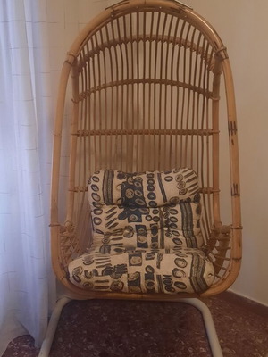 Hanging vintage armchair made of natural rattan with metal base and cushions, like new