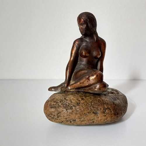 Vintage bronze Little Mermaid statue on natural stone used
