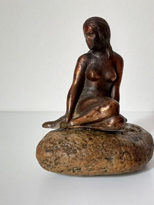 Vintage bronze Little Mermaid statue on natural stone used