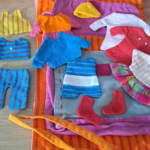 Cloth bag with doll and clothes used