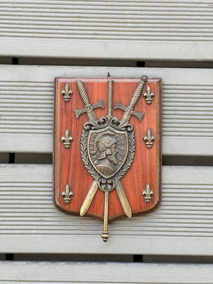 Vintage wooden wall shield with metal coat of arms, swords & fleur-de-lis used