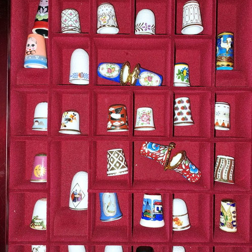 Porcelain thimble collection with wooden display case and book