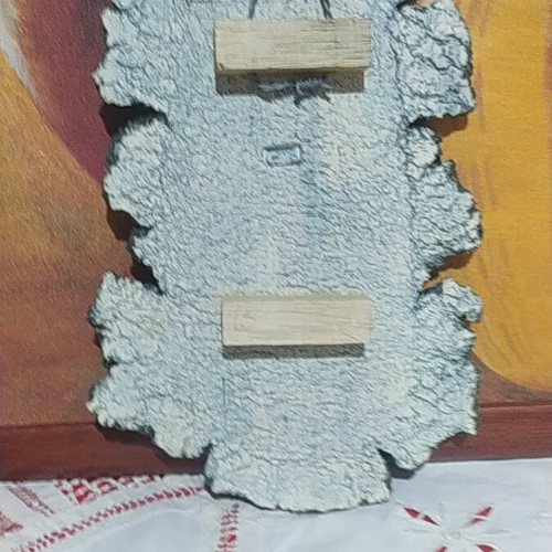 Handmade stone wall decoration with embossed ancient-style faces