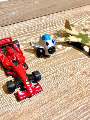 Collection of toy airplanes and Formula 1 car used