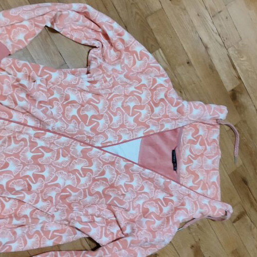 Pink cardigan used with white patterns and zipper, size L