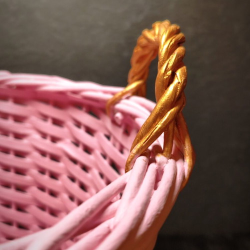 Decorative pink rattan basket with gold handles, handmade