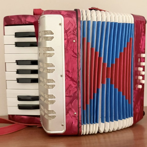 Children's accordion used, red with blue and red bellows