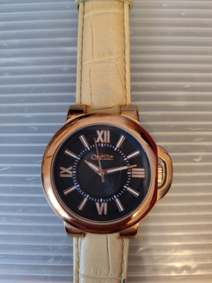 Oxette watch used with black dial, rose gold metal and beige strap