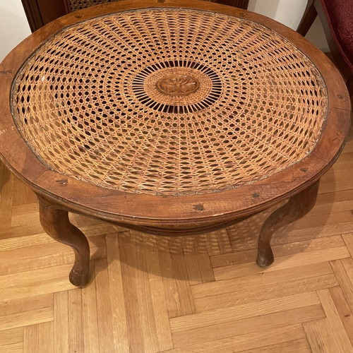Oval living room coffee table with rattan and carved medallion