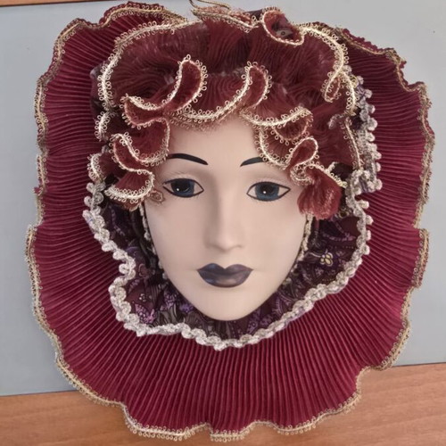 Decorative porcelain wall mask used with fabric hat in burgundy