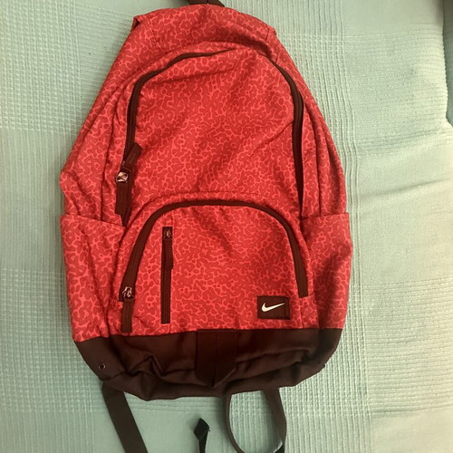 Nike backpack with one broken zipper, like new, black and red