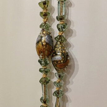 Tabletop komboloi with green and gold glass beads