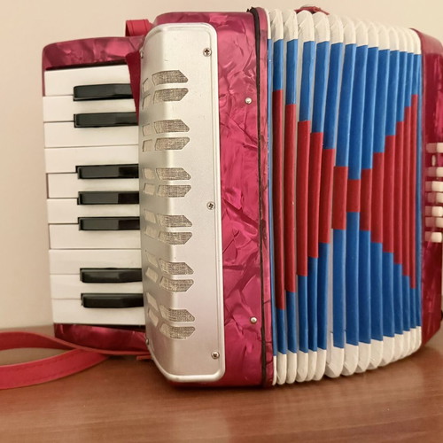 Children's accordion used, red with blue and red bellows