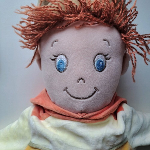 Cloth doll with hat and orange details like new