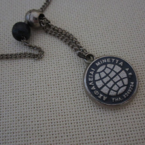 Vintage komboloi used with Minetta insurance company emblem