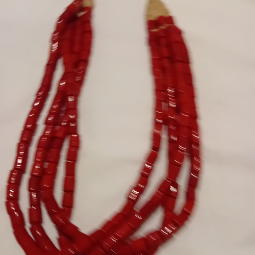 Red multistrand necklace used with cylindrical beads and woven clasp