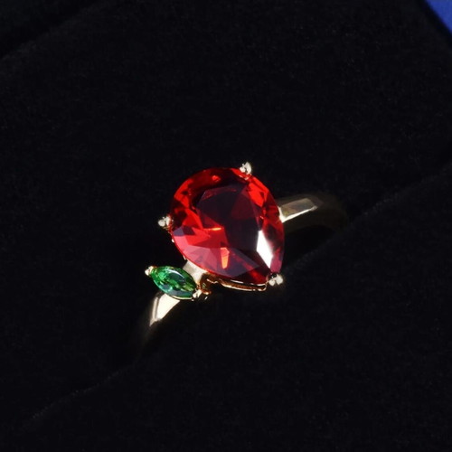 Adjustable ring with red teardrop stone and green detail, gold plated