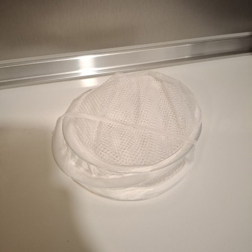 Foldable mesh storage basket white used for laundry and toys