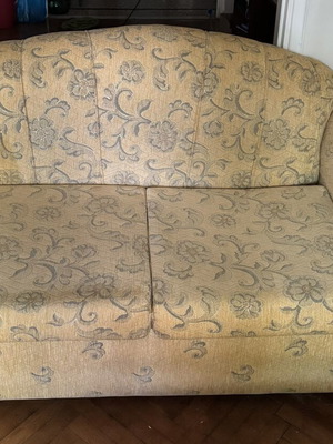 Vintage two-seater sofa with wooden legs and removable covers