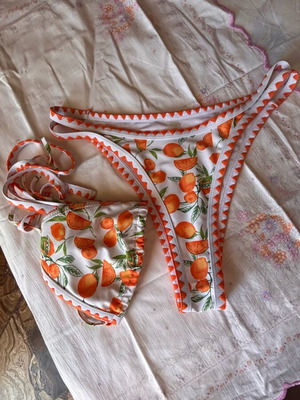 Women's swimsuit like new, white and orange with orange print, size M