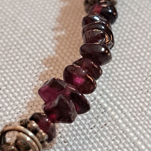 Necklace with purple beads and metallic butterfly and star charms