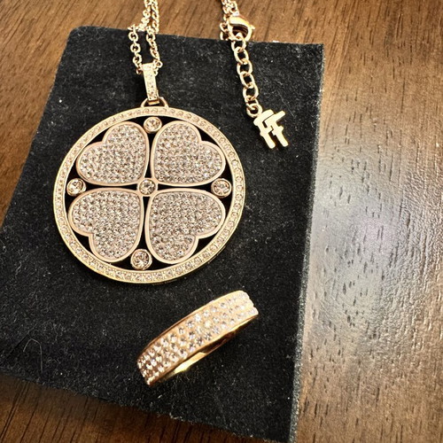 Folli Follie jewelry set with double-sided long necklace, hoop earrings, and two rings