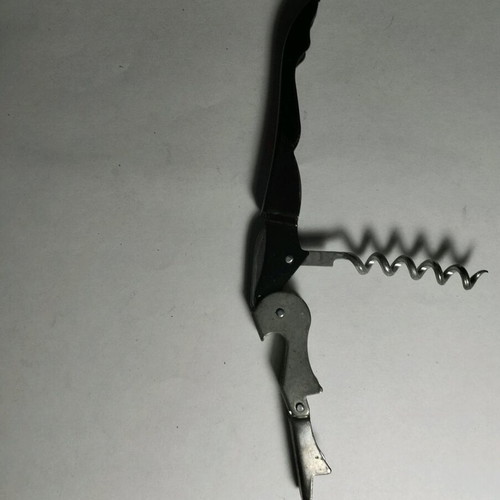 Black bottle opener used for soft drinks and wine